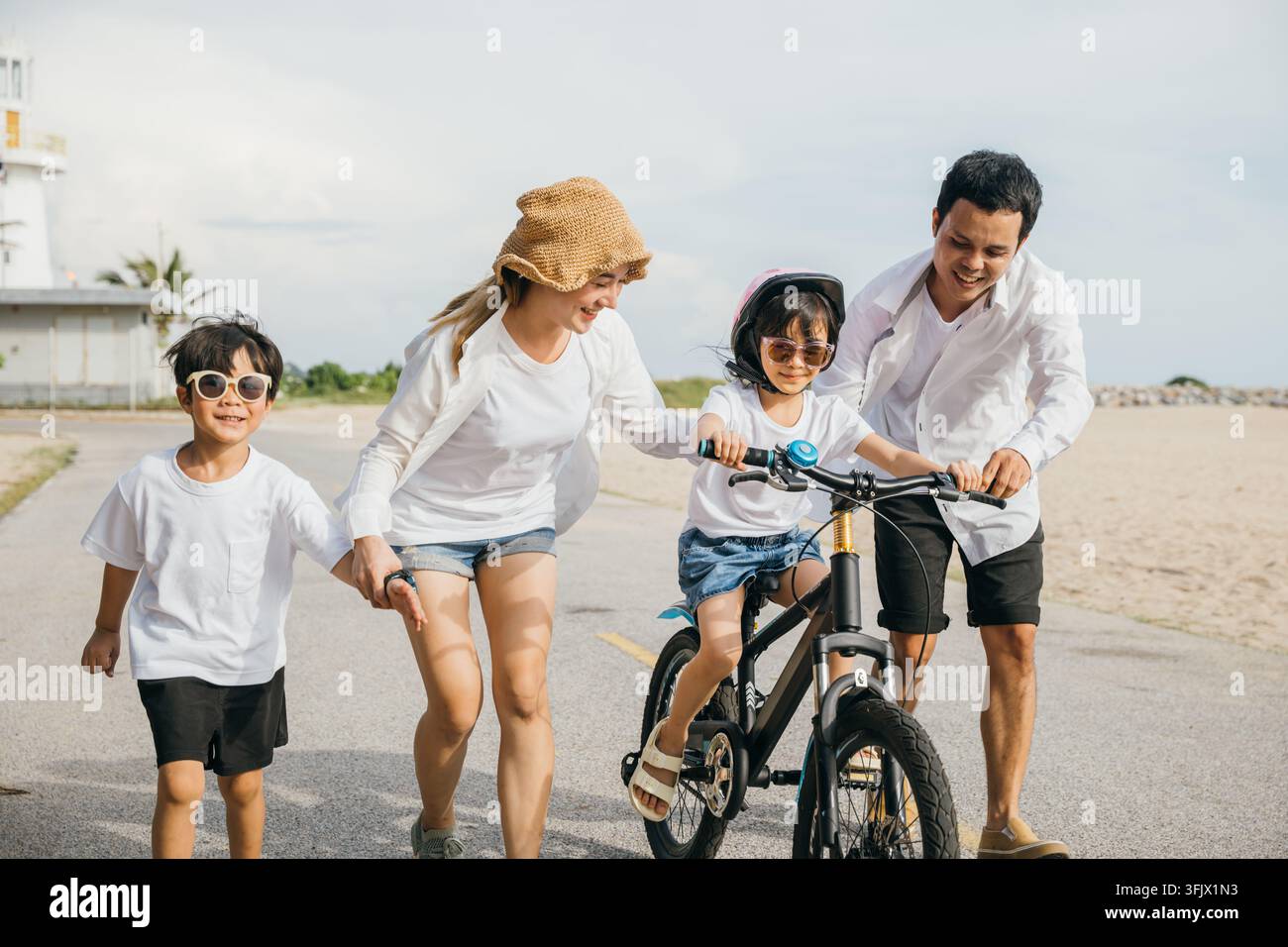Sunset happiness on a sandy beach, A cheerful family enjoys a road trip ...