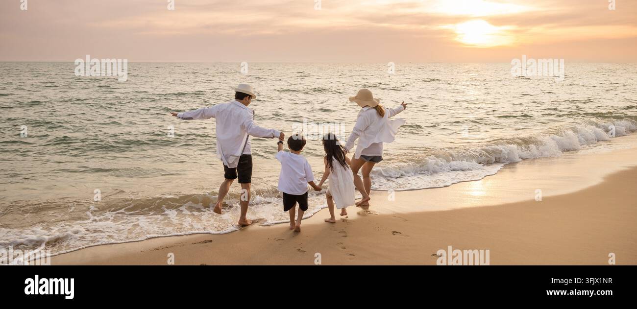 An idyllic beach scene during sunset where parents join their kids for ...