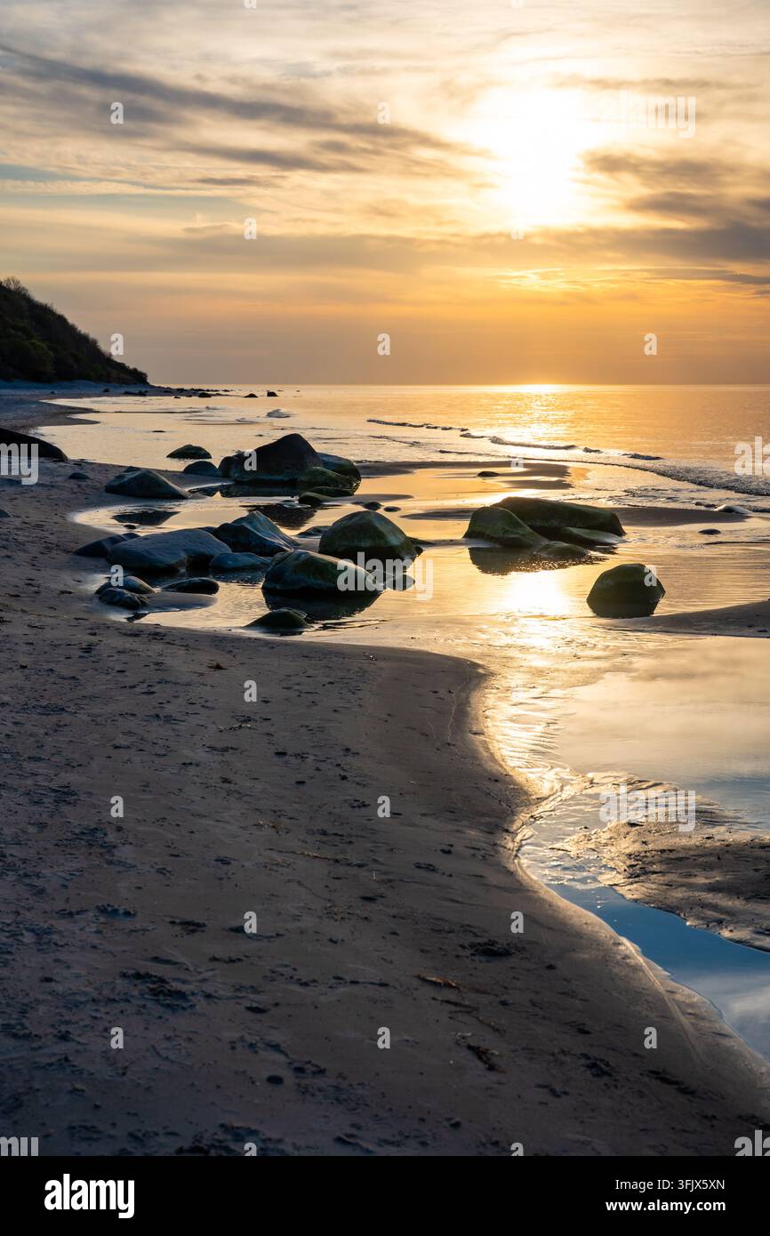 Rocky beach coastline on Ruegen island in Germany during sunset over ...