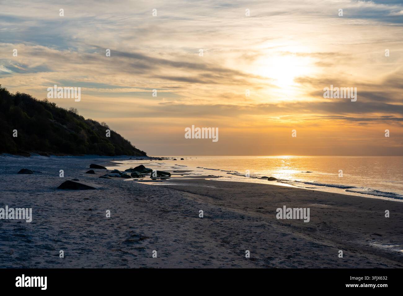 Rocky beach coastline on Ruegen island in Germany during sunset over ...