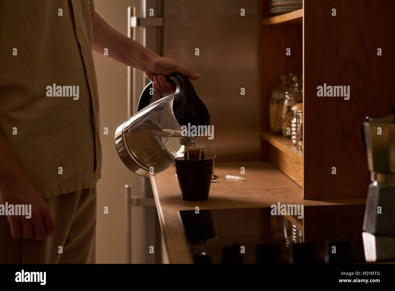 Man Pouring Hot Water from Kettle into Drip Coffee Cup Stock Photo