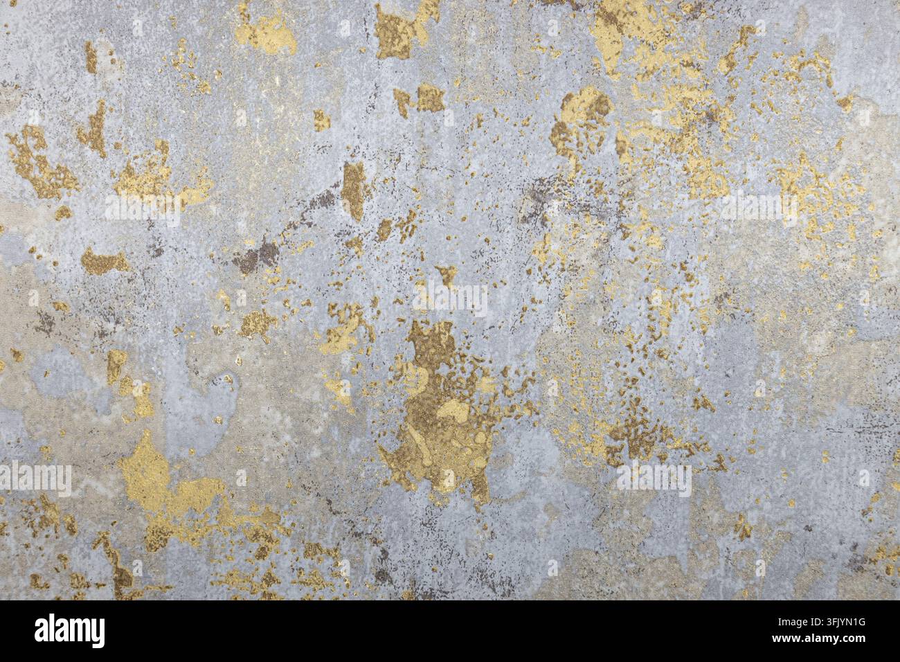Abstract distressed wall texture with weathered gold leaf Stock Photo