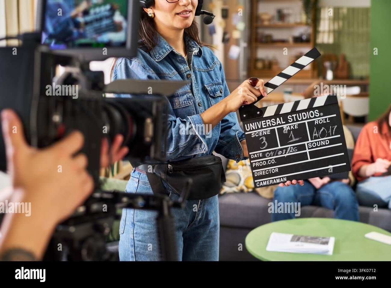 Woman Holding Clapperboard during Video Production Stock Photo