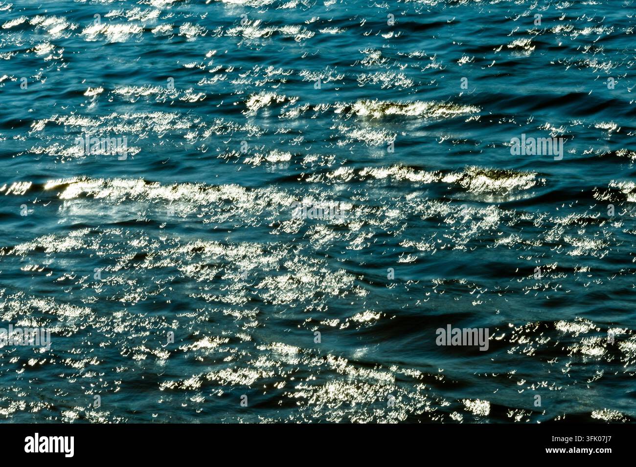 Bright sunlight glitters on rippling waves Stock Photo