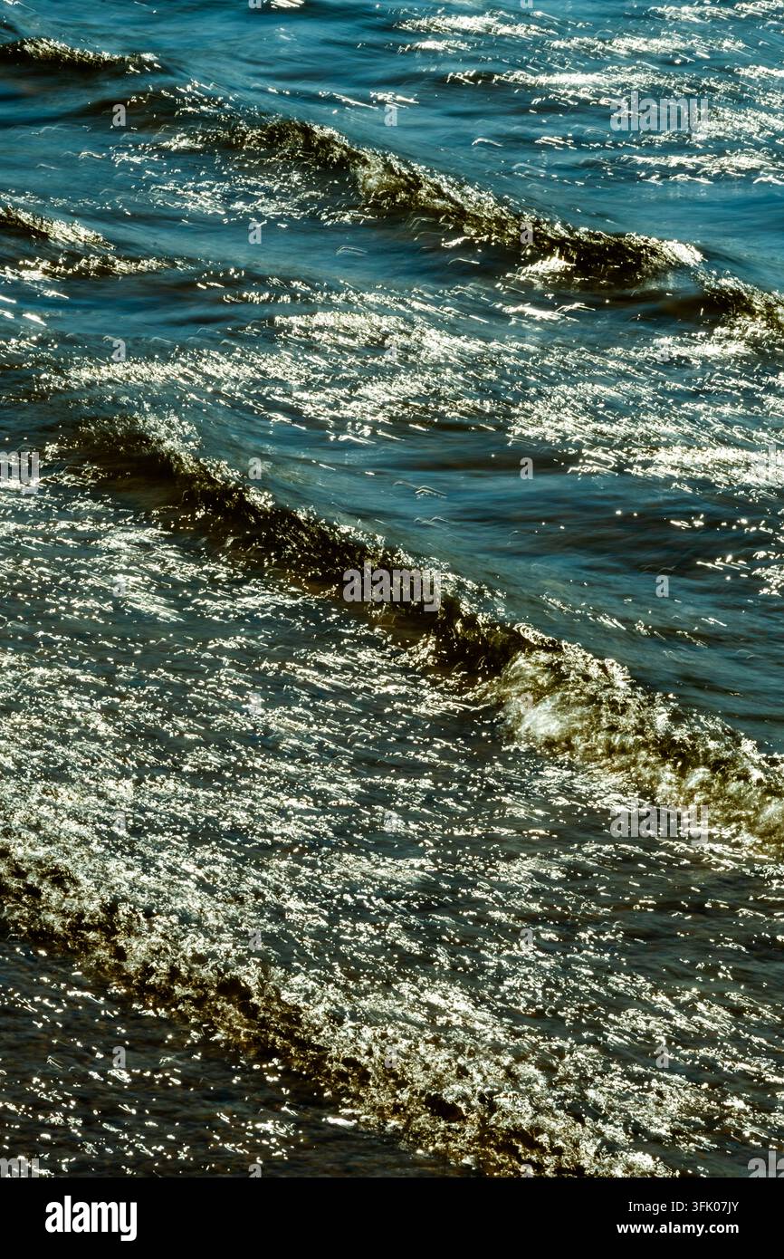 Bright sunlight glitters on rippling waves Stock Photo