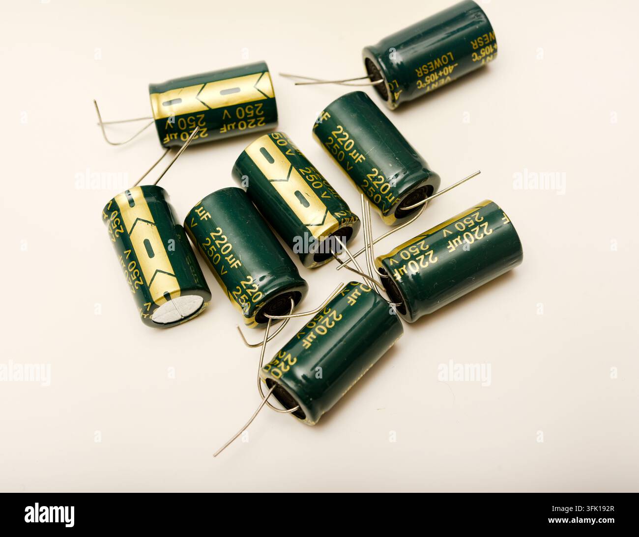 Green electrolytic capacitors on a white background. Electronic components. Charge storage devices. Stock Photo