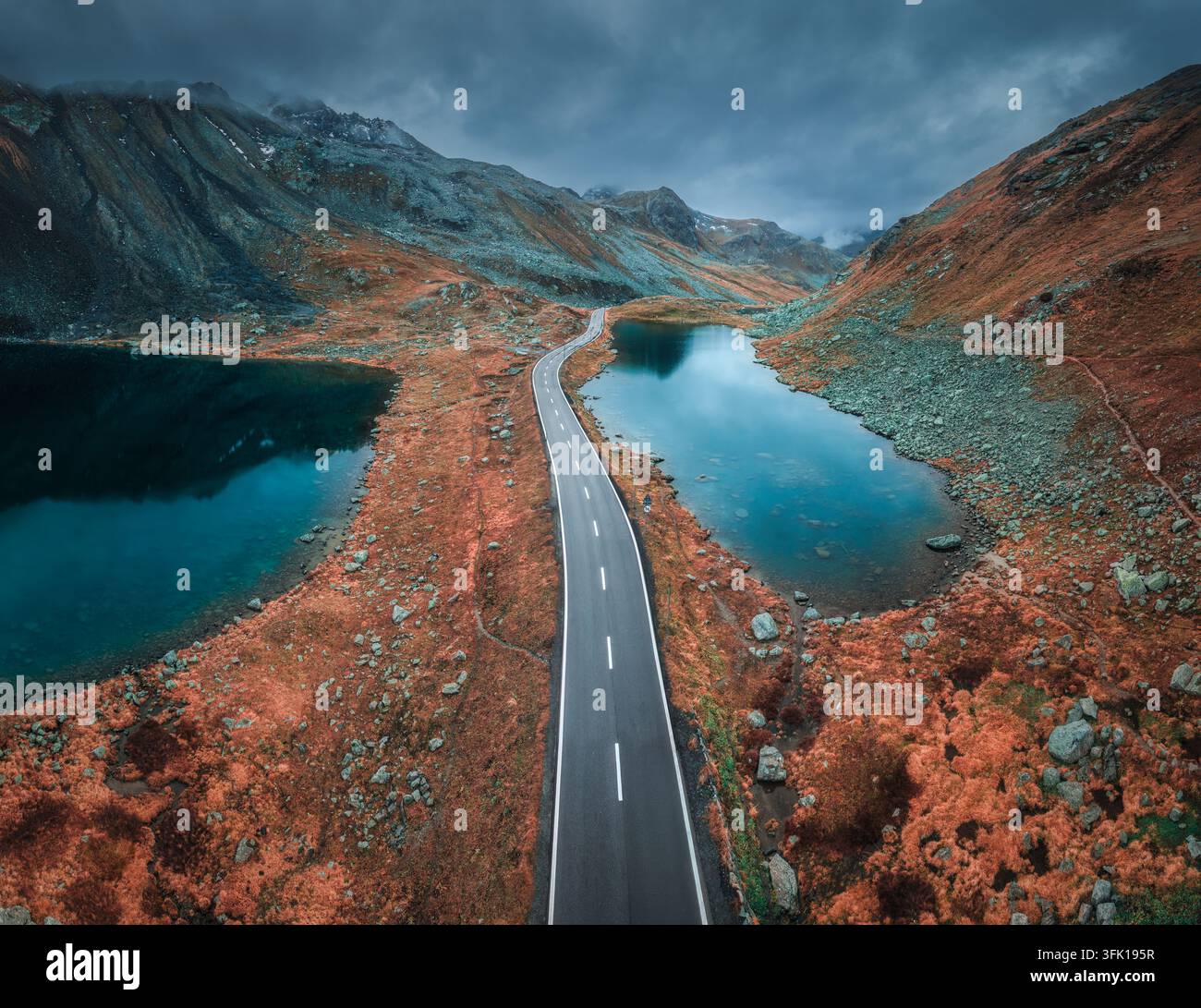 Aerial view of mountain road between two lakes in alpine valley Stock Photo