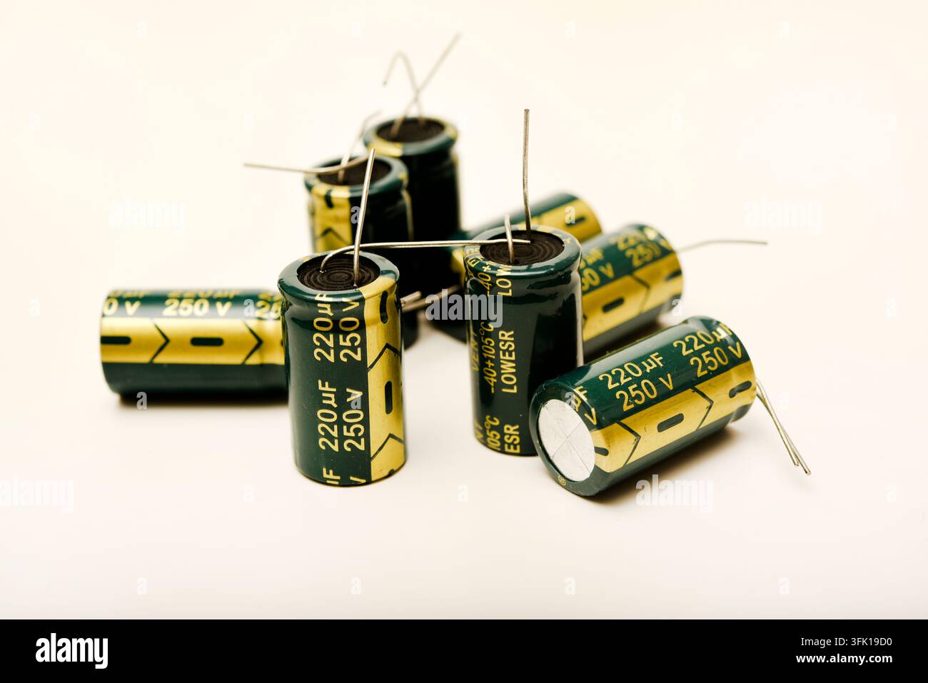 Green electrolytic capacitors on a white background. Electronic components. Charge storage devices. Stock Photo