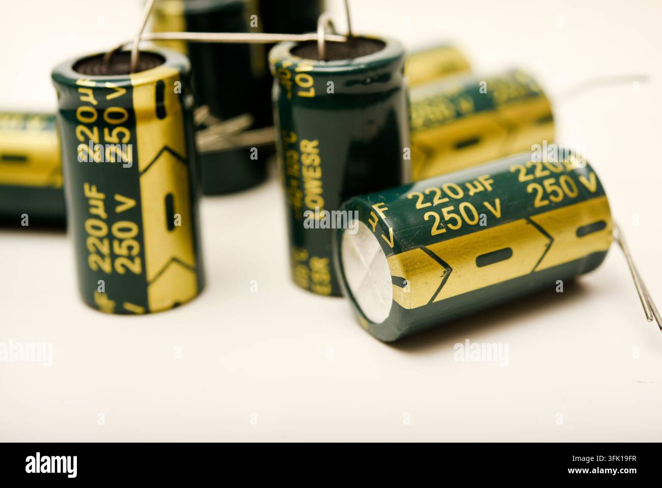 Green electrolytic capacitors on a white background. Electronic components. Charge storage devices. Stock Photo