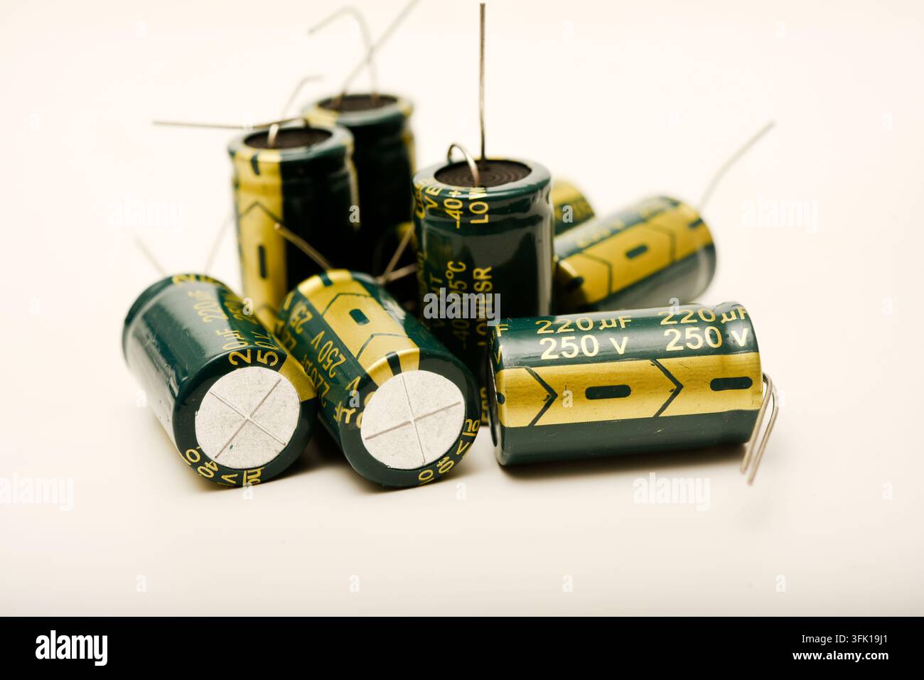 Green electrolytic capacitors on a white background. Electronic components. Charge storage devices. Stock Photo