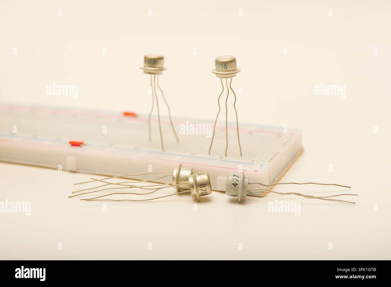 Transistors in a metal casing. Semiconductor components on a breadboard. Stock Photo