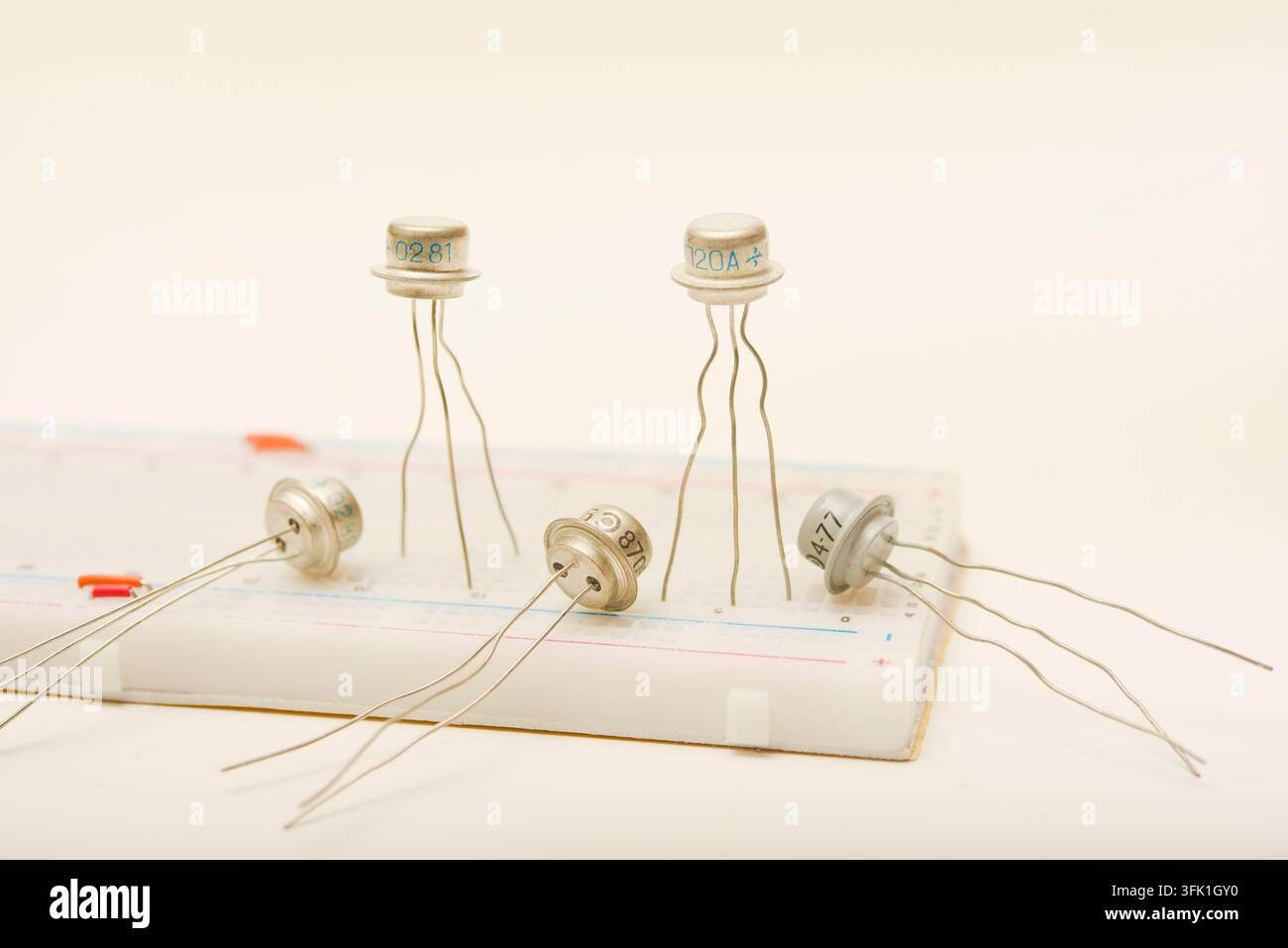 Transistors in a metal casing. Semiconductor components on a breadboard. Stock Photo