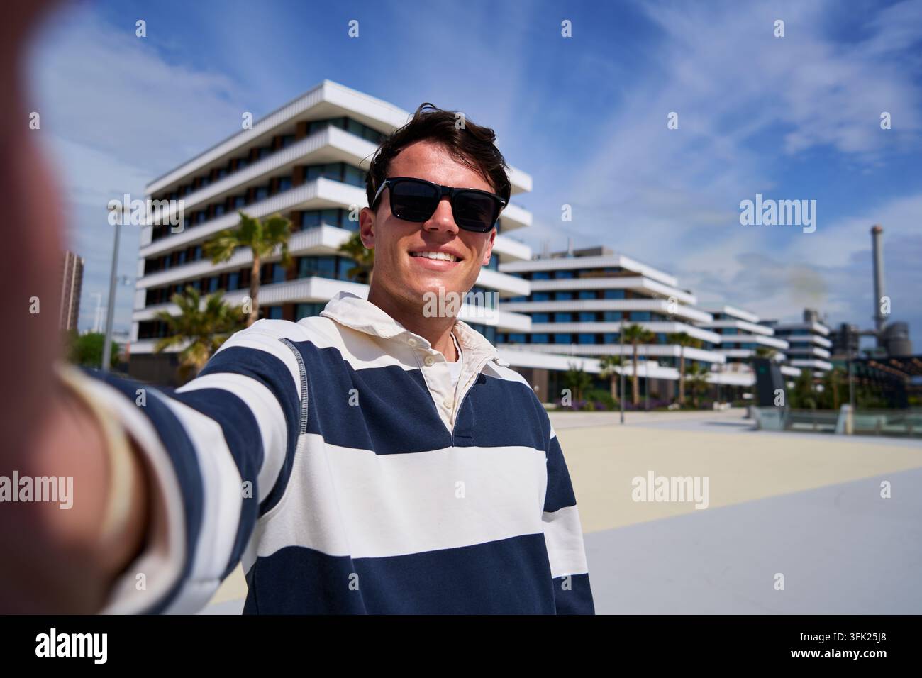Young man taking selfie outdoors. Stock Photo
