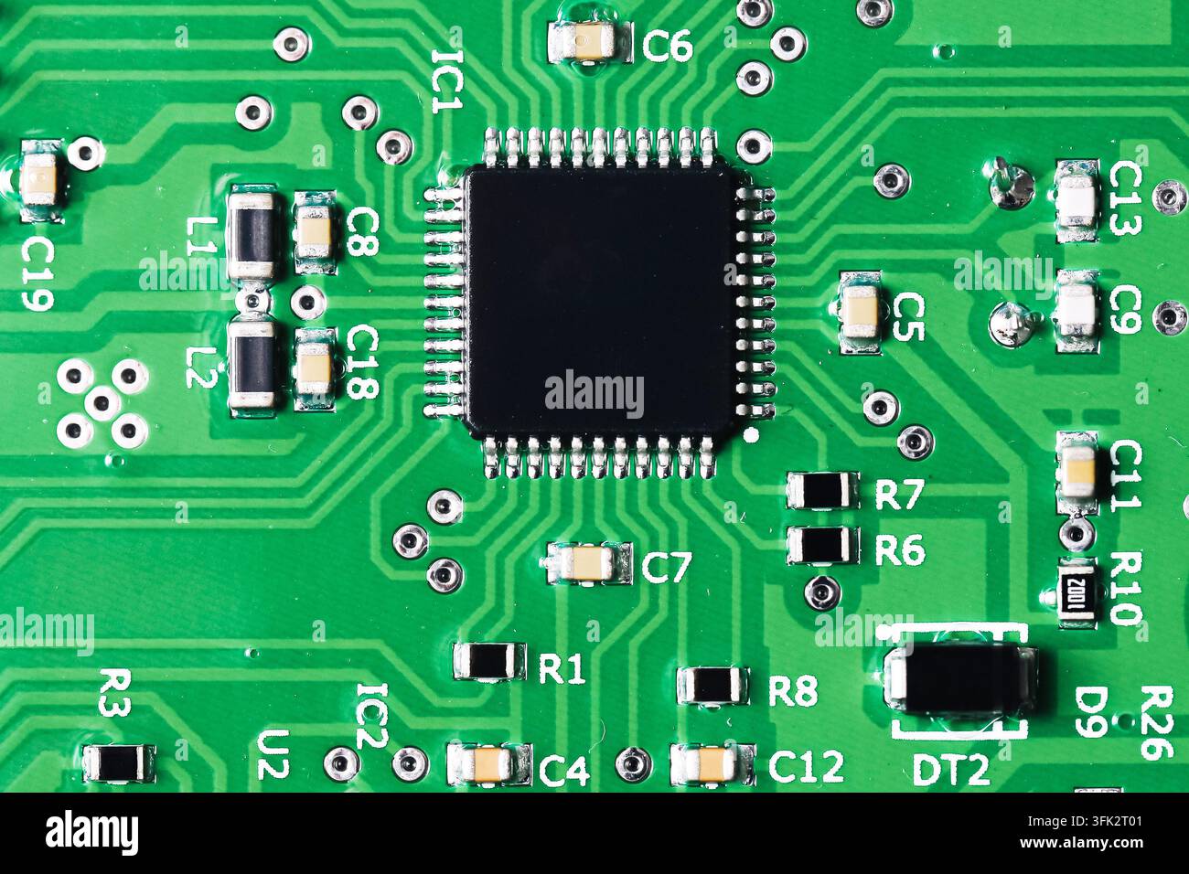 Green electronic circuit board with microchip. Technology background for electronics engineering components hardware computing and digital systems. Stock Photo