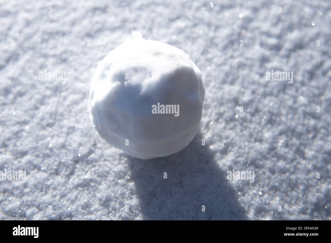 Snowball on snow background. Snowball with icy texture. White snowball ...