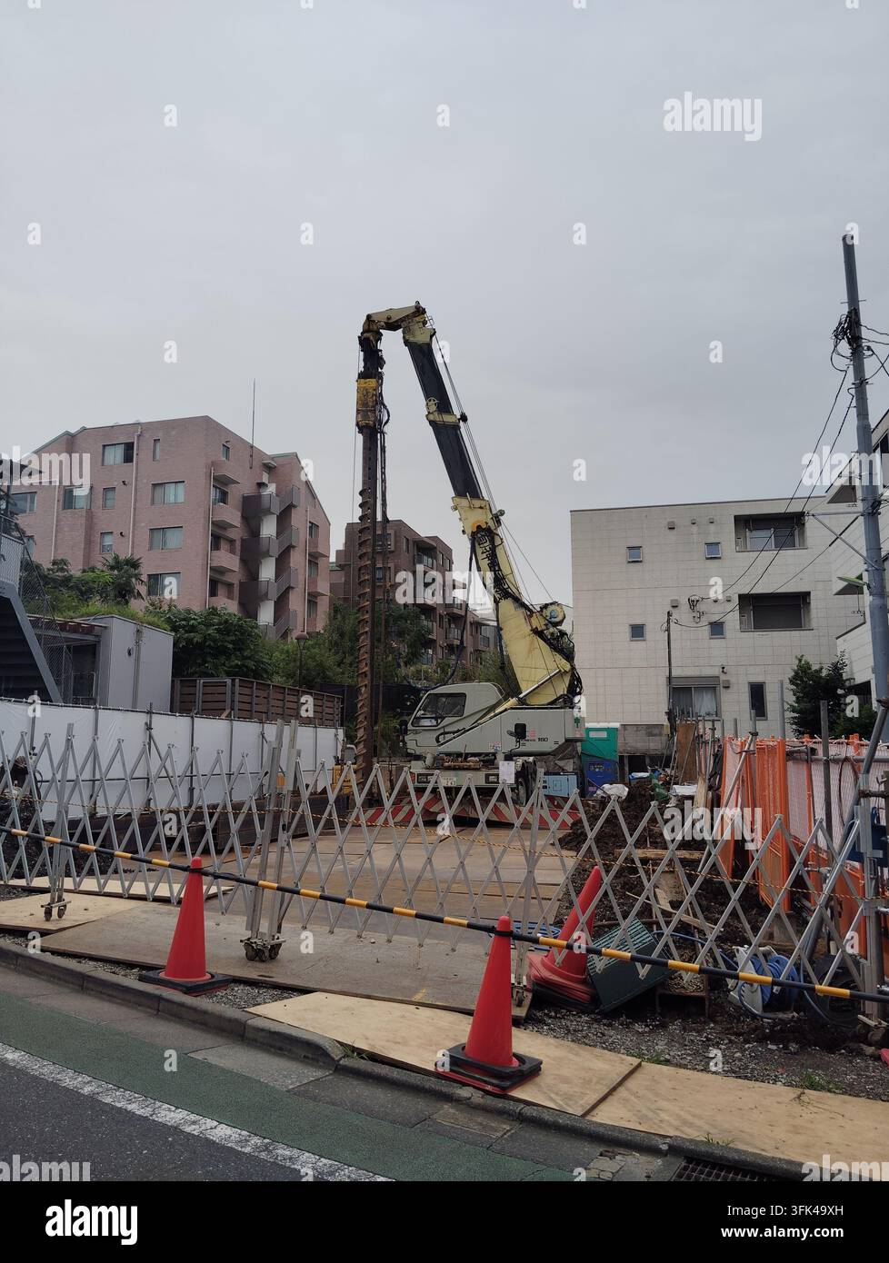 Pile drilling machine operating at a construction site in a residential area of Tokyo, Japan. - Smartphone Captured Stock Image
