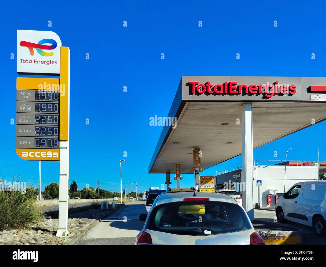 Fos Sign In A line of drivers waits to fill up at a Total gas station maintaining ...
