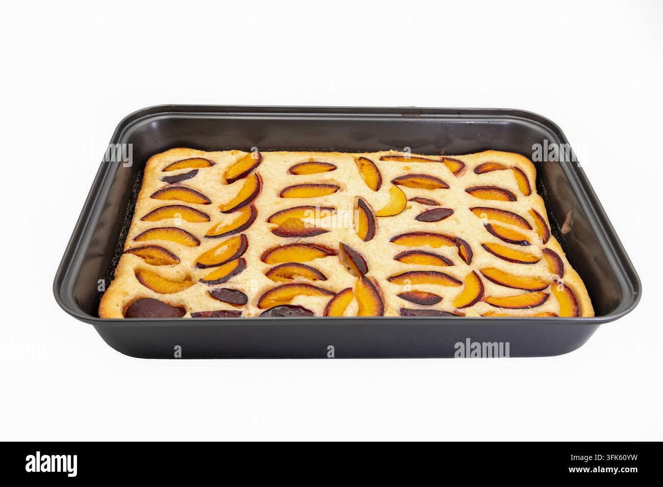Homemade Plum Cake Baked in a Rectangular Pan on White Stock Photo