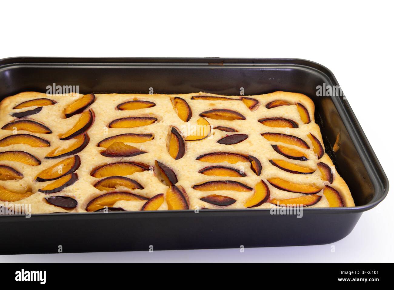 Homemade Plum Cake Baked in a Rectangular Pan on White Stock Photo