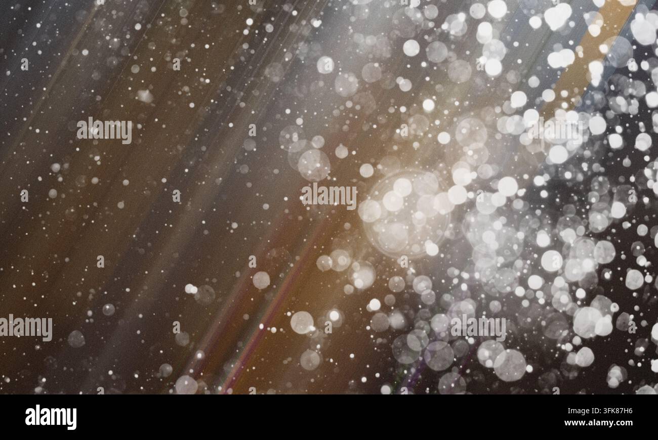 Abstract background with soft brown and grey tones, featuring glowing bokeh circles and subtle light streaks, perfect for creative design projects. Stock Photo
