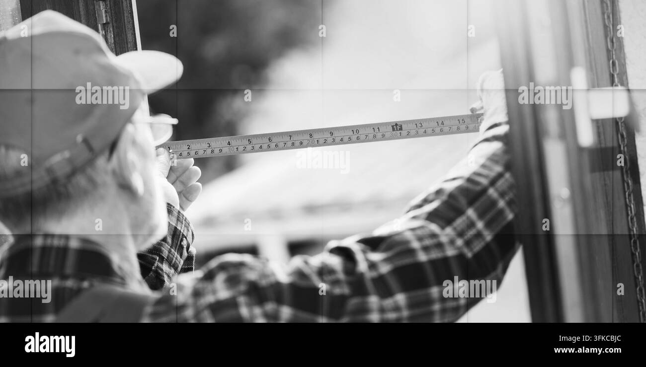 Senior repairman taking measures with tape measure, light effect, geometric pattern Stock Photo