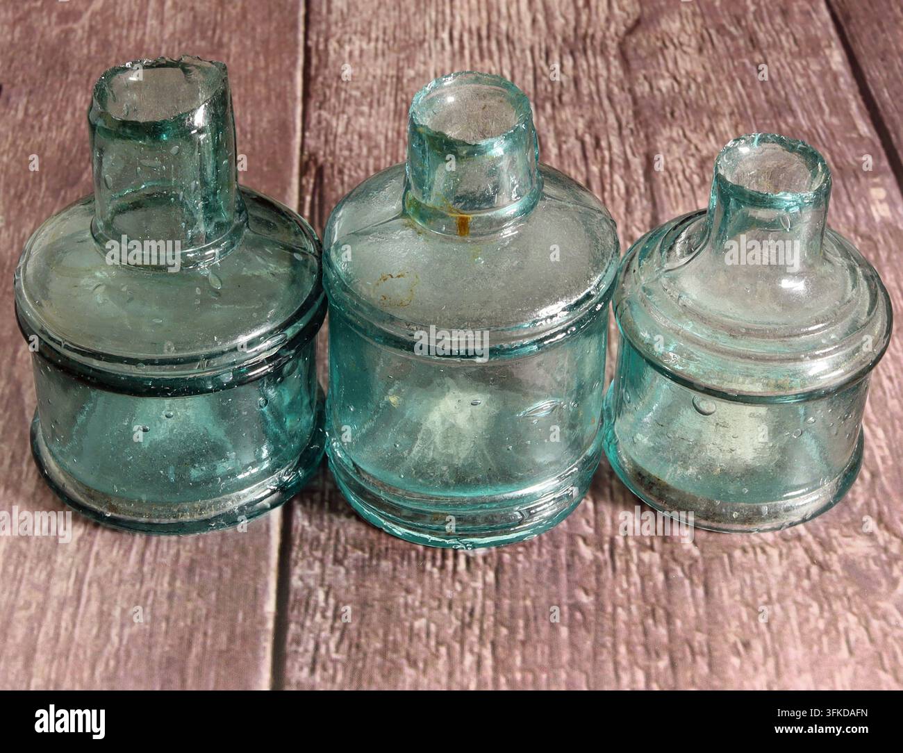 Three cotton reel, antique sheared top ink bottles Stock Photo