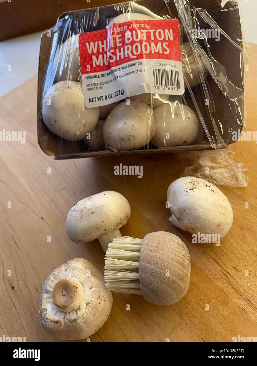 A mushroom brush is a kitchen tool used to dry clean debris and dirt from fresh white button mushrooms, 2026, USA - Smartphone Captured Stock Image