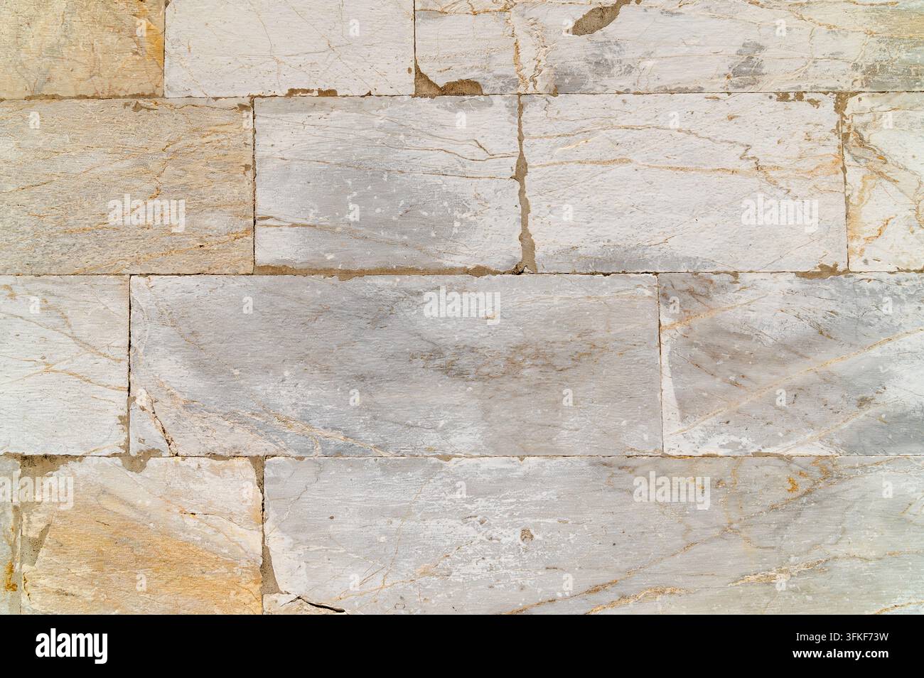 Marble tile wall displaying rectangular blocks in neutral tones. Stock Photo
