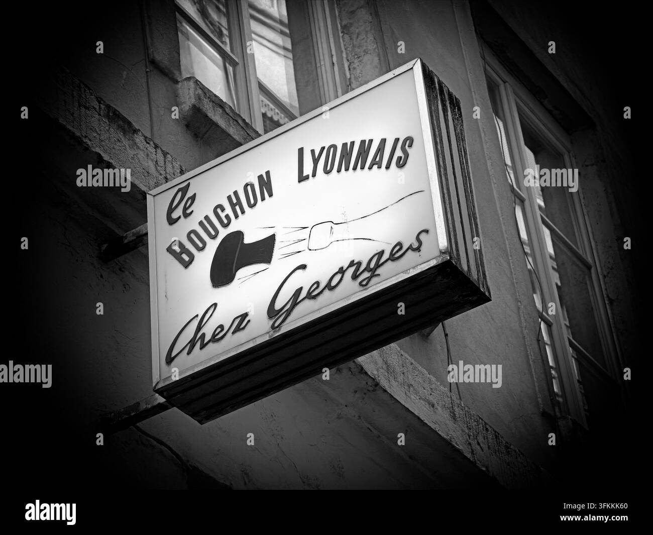 Illuminated sign for Au Petit Bouchon 'Chez Georges', a traditional bouchon lyonnais in central Lyon. Stock Photo
