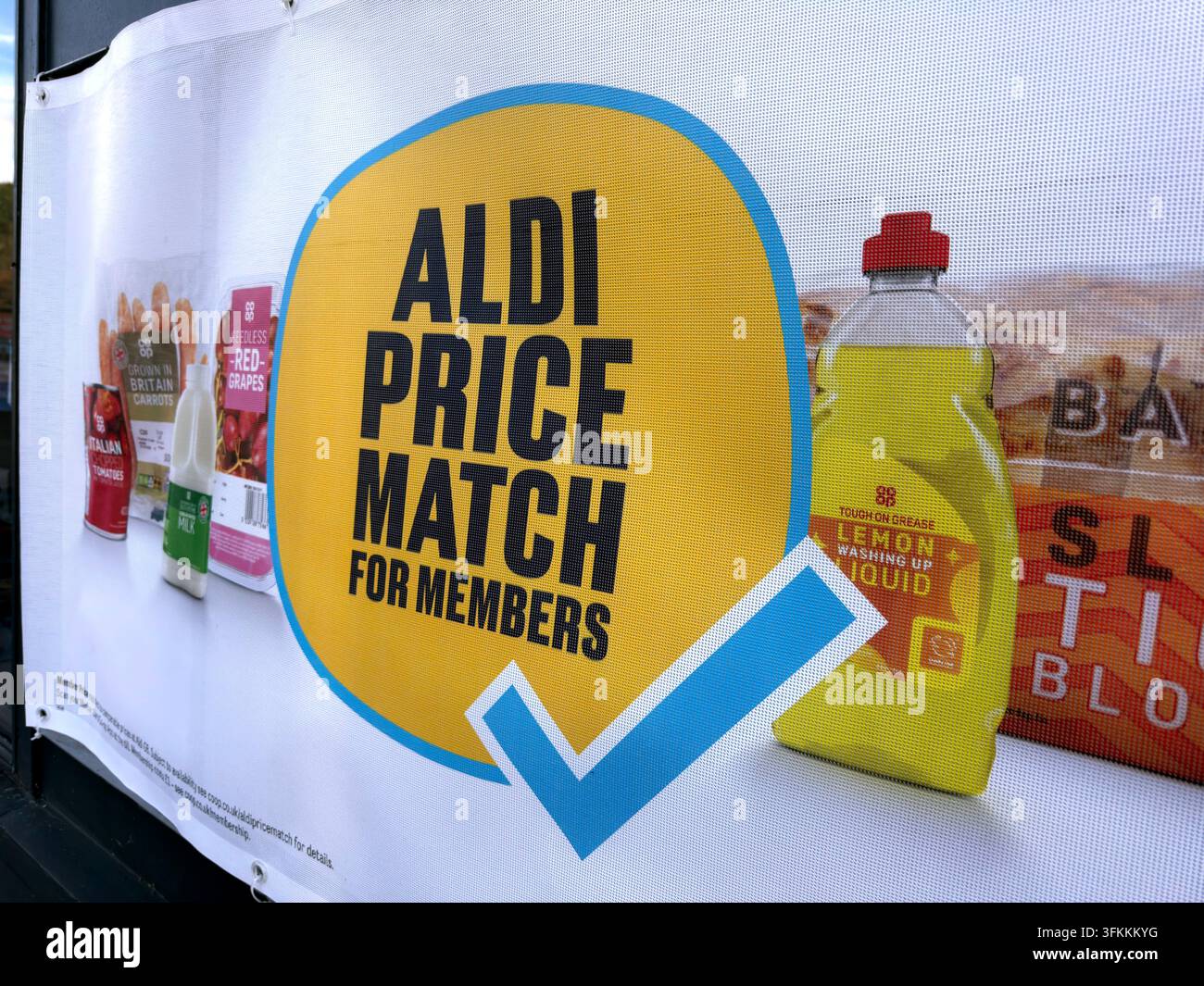 Co-op poster promotes an Aldi Price Match available to members in a UK food store. Stock Photo
