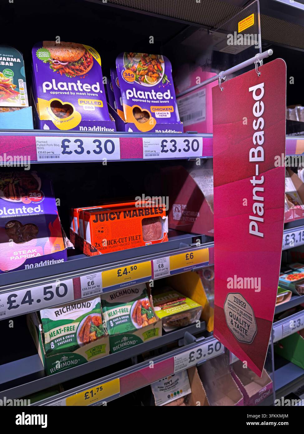 Plant-based UK supermarket products imitate familiar meat formats (burgers, steaks, sausages), in a chilled vegetarian and vegan food display. Stock Photo