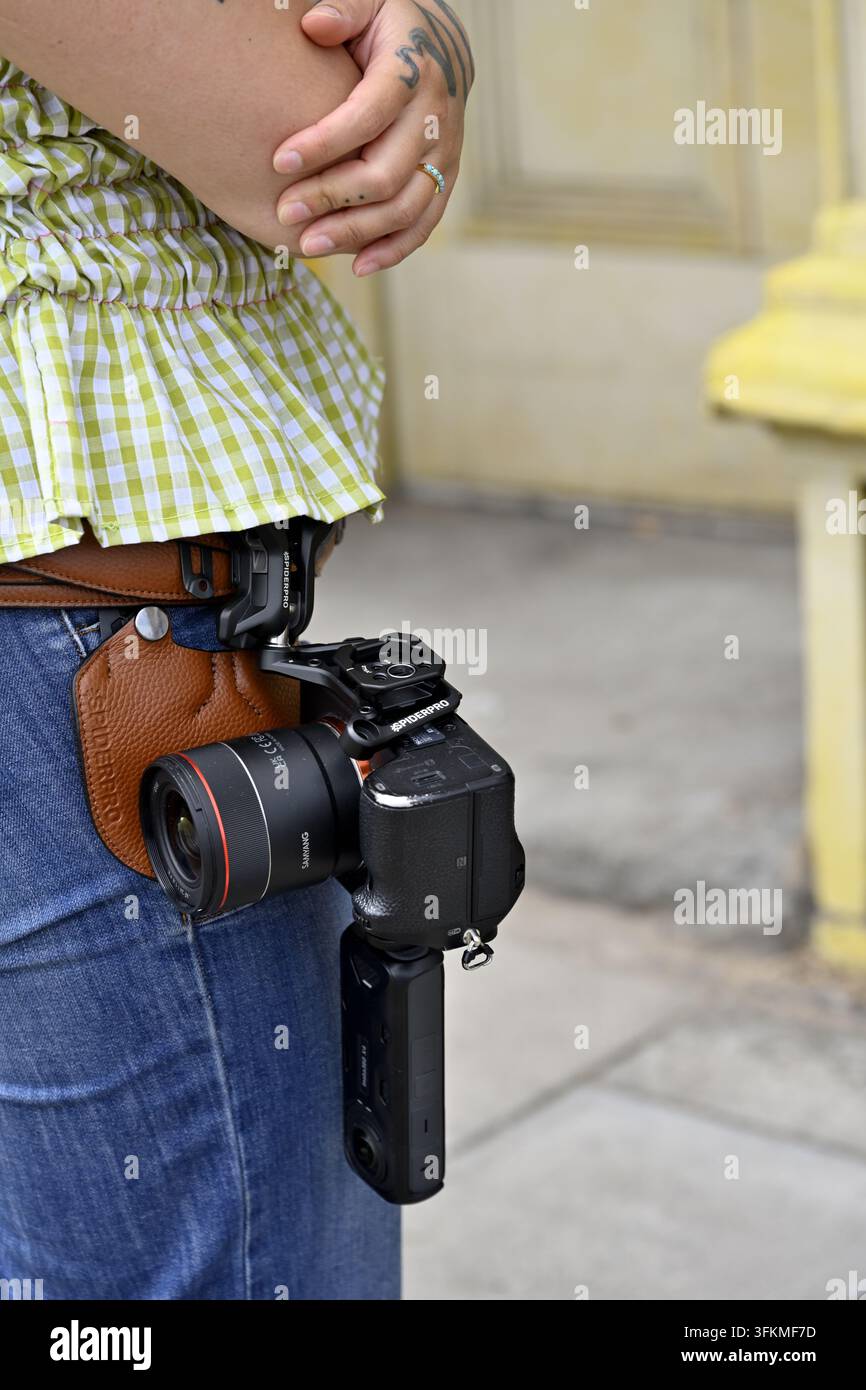 Photographer with Sony camera on waist hanging on Spider Camera Holster system Stock Photo