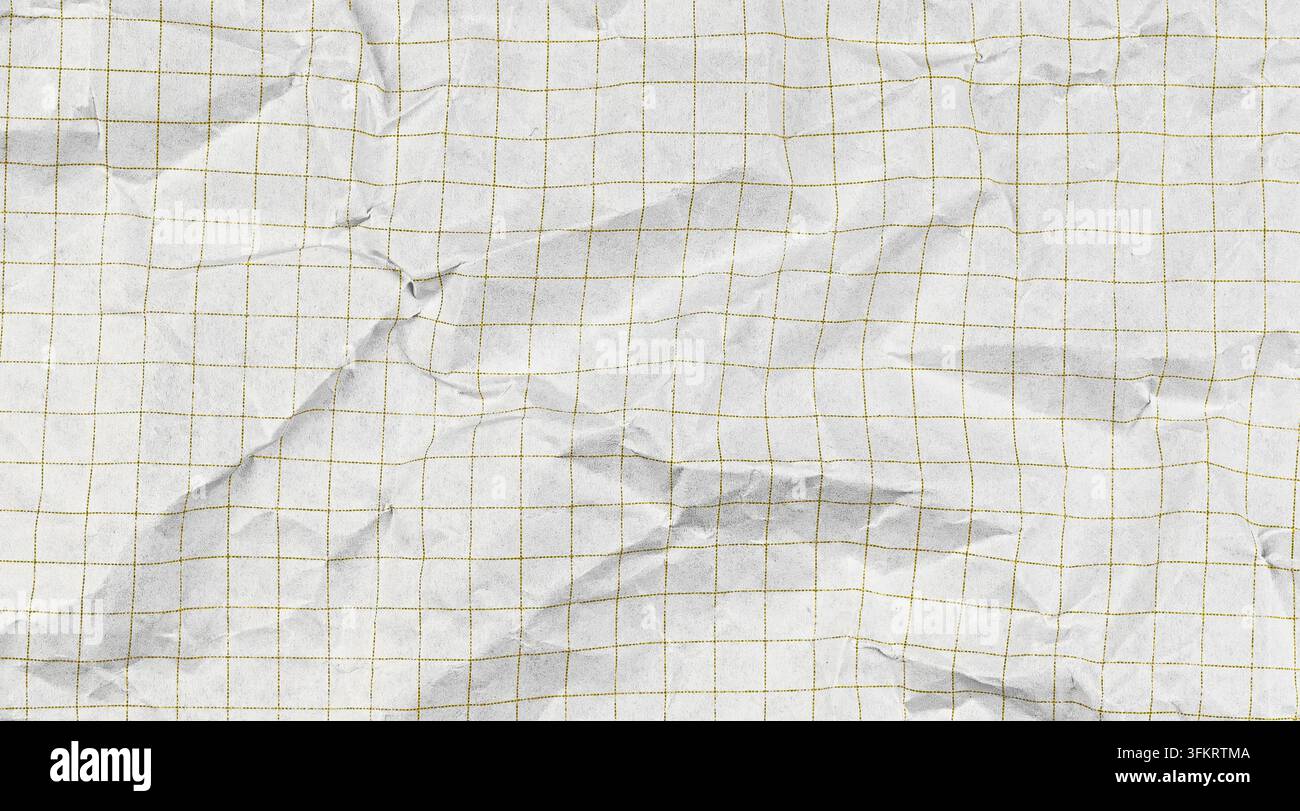 Crumpled paper notebook sheet with checkered grid pattern. White graph background for school math education projects and geometric study materials. Stock Photo