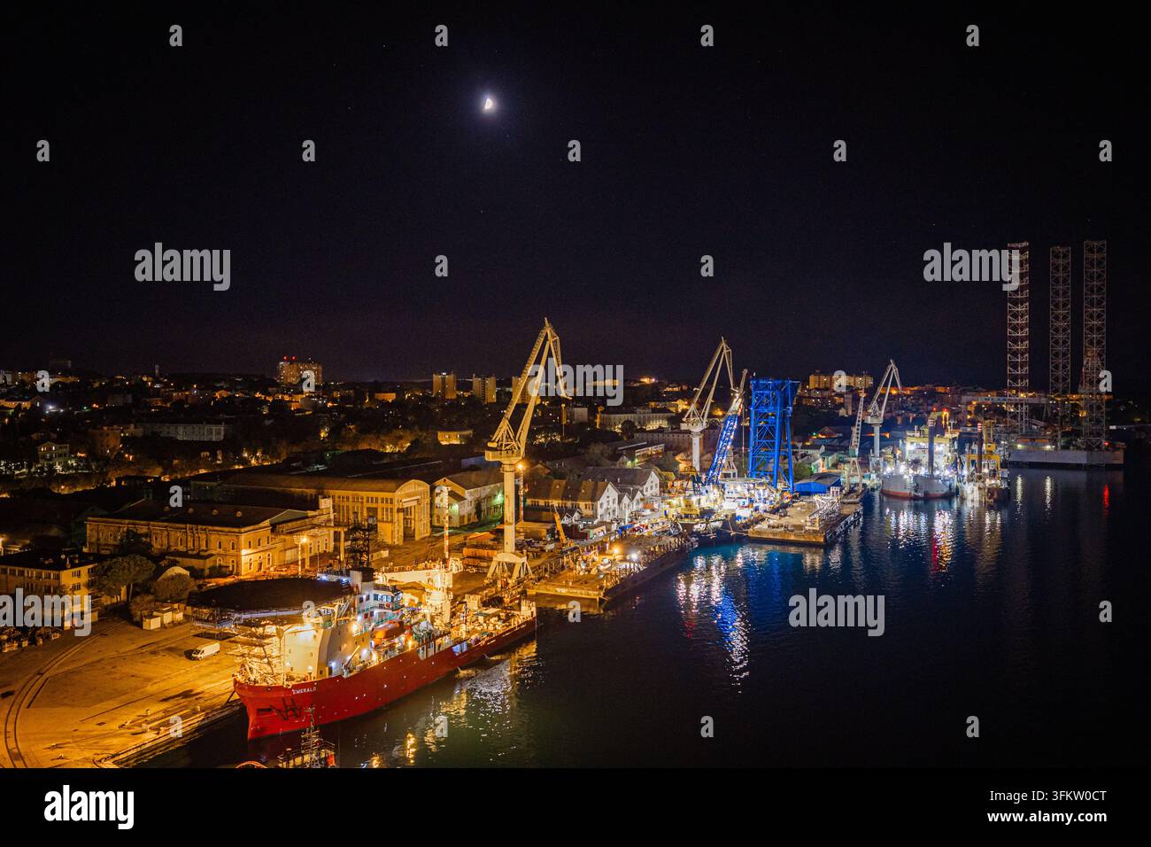 Aerial view of the illuminated Uljanik shipyard at night with ...