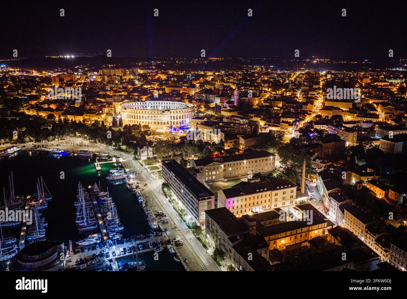 Aerial view of the illuminated Pula Arena amphitheater at night ...
