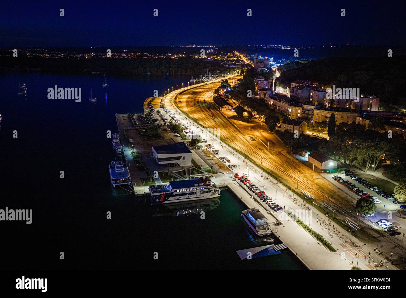Aerial view of the illuminated waterfront and harbor at night ...