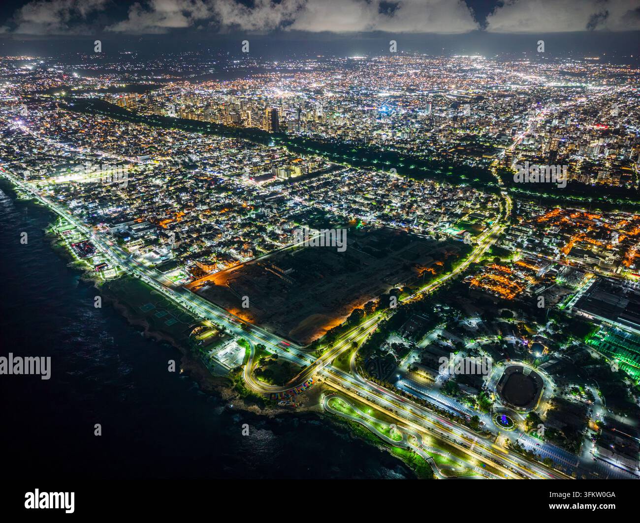 Aerial view of Feria Ganadera illuminated at night along the coastline ...