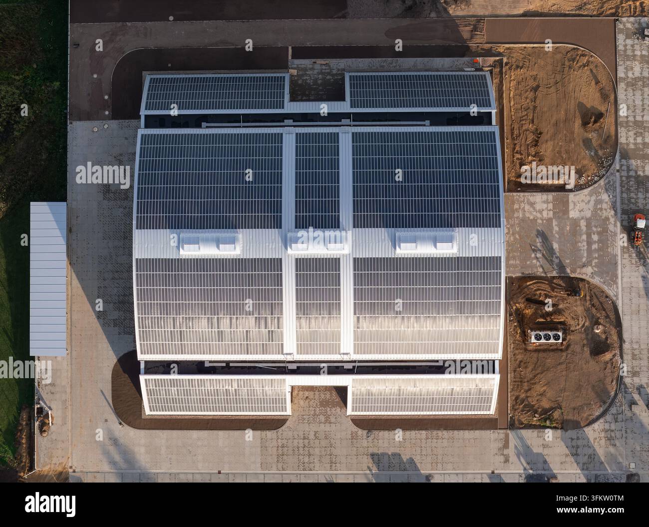 Aerial view of a large industrial building with extensive solar panel ...