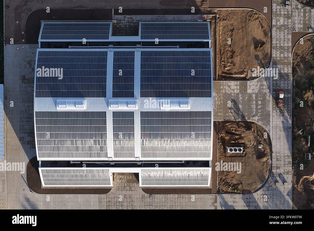 Aerial view of a large building with extensive solar panel arrays on ...