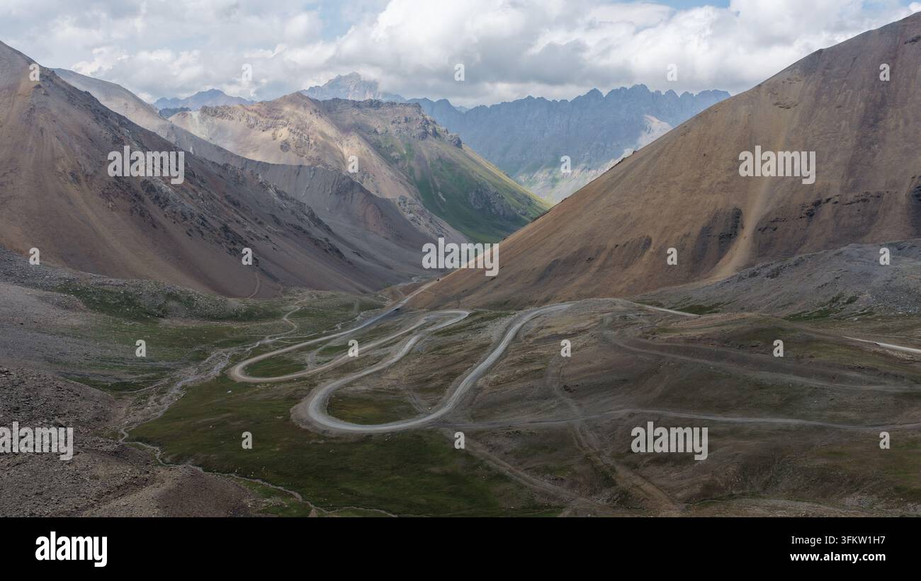 Aerial view of the winding mountain road through the Enilchek valley ...