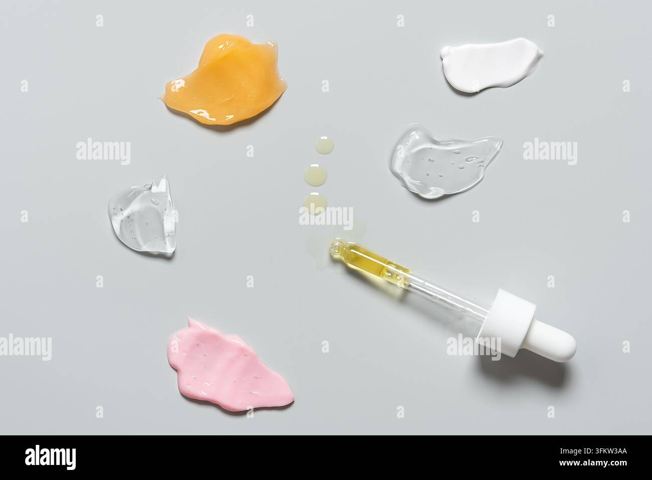 Various samples of cosmetic skin care products on gray pastel ...