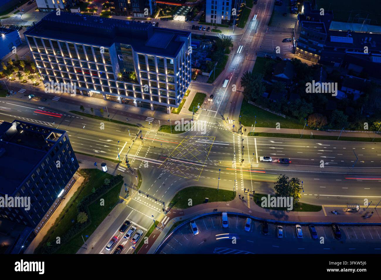 Aerial view of a modern urban intersection at night with illuminated ...