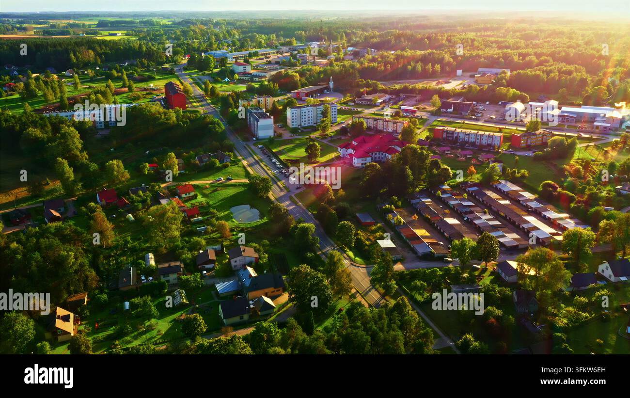 Aerial view of a residential area in a small town surrounded by lush ...