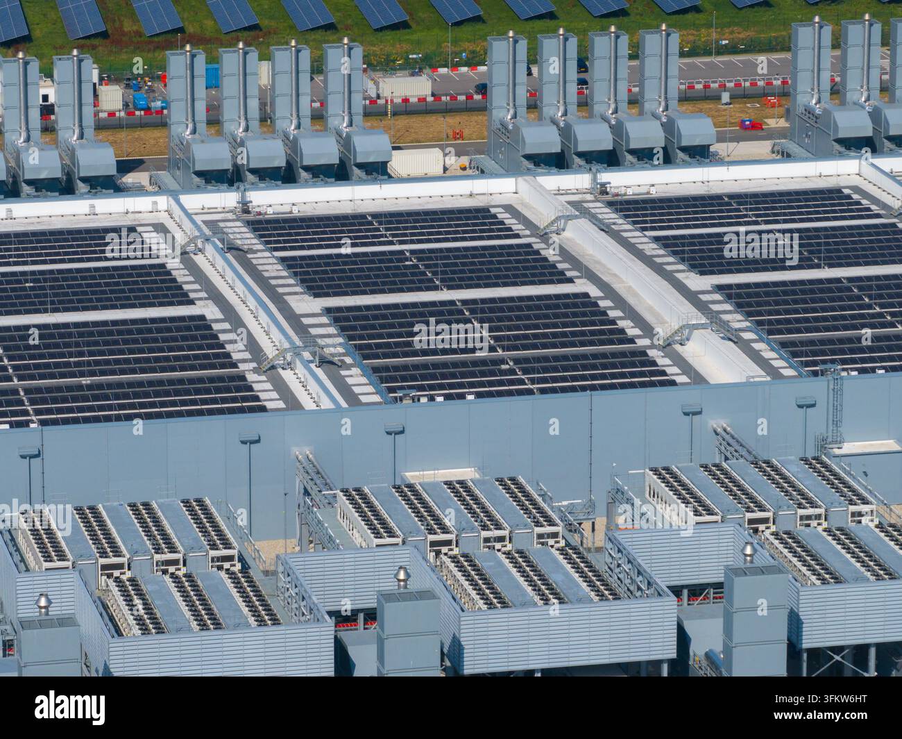 Aerial view of a large datacenter featuring extensive rooftop solar ...