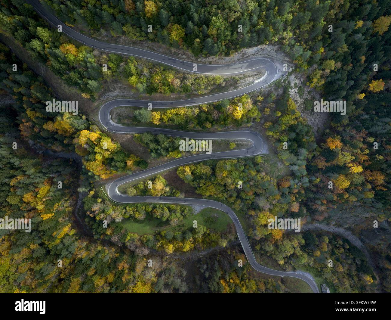 Aerial view of a winding mountain road through the Pyrenees forest with ...