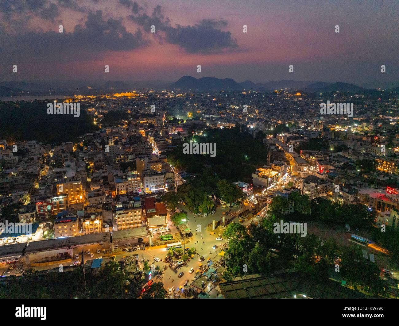 Aerial view of the illuminated cityscape of Udaipur at night with ...