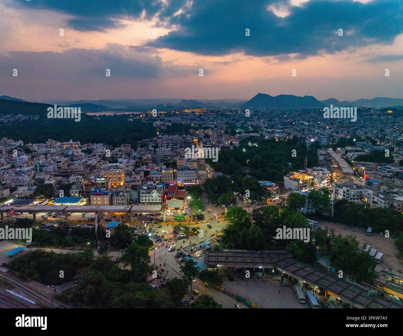 Aerial view of Udaipur at dusk, showing the city skyline, illuminated ...