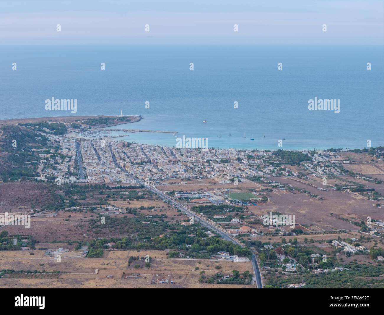 Aerial view of the coastal town with white buildings, harbour, and ...
