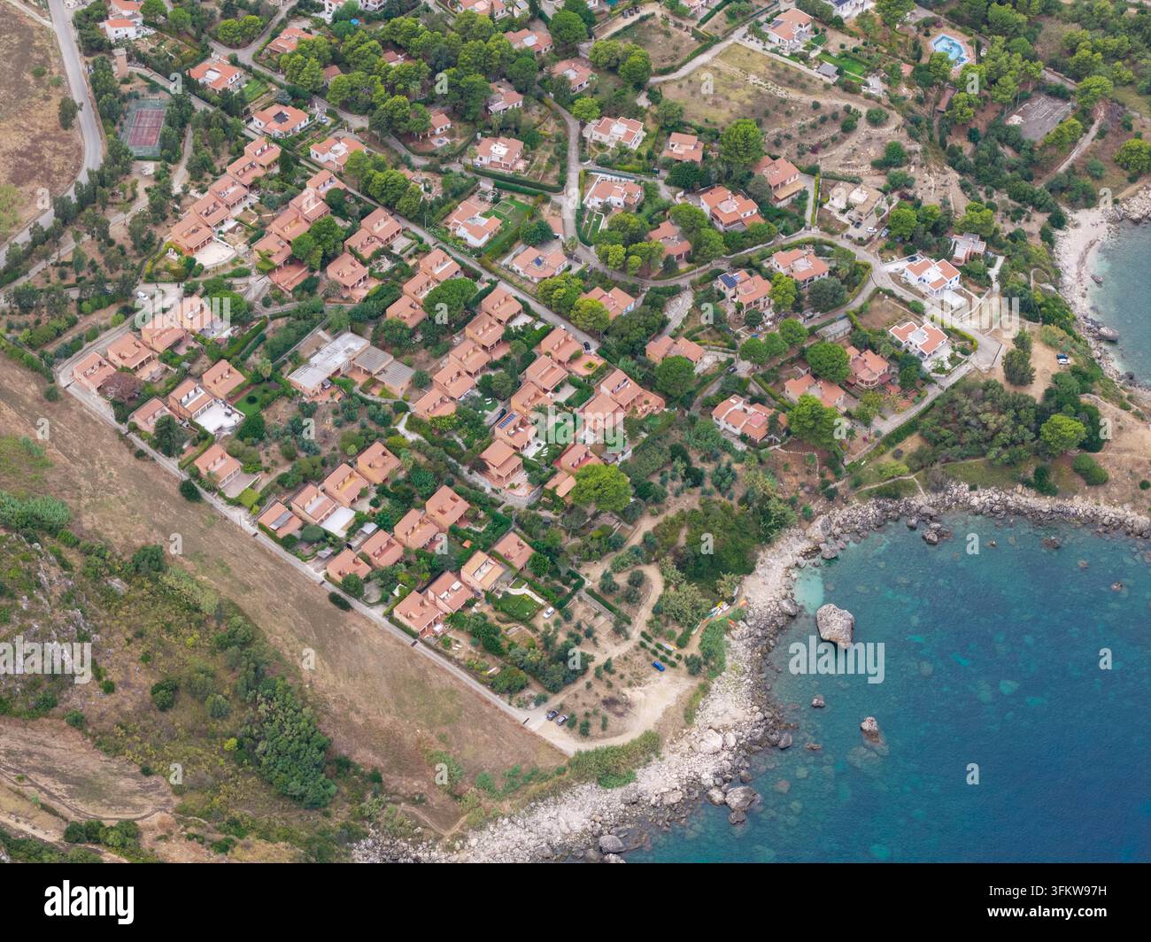 Aerial view of villas with terracotta roofs near Riserva Naturale ...