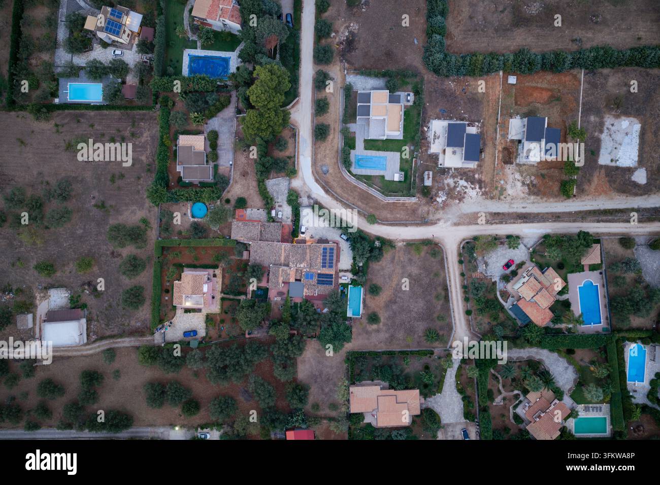 Aerial view of residential villas with swimming pools and olive groves ...